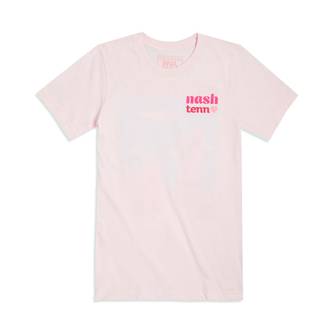 Full front view of the light pink Cityscape tee.  Left chest art says Nash Tenn with a heart in shades of pink.  